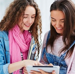 Two female students looking at a tablet