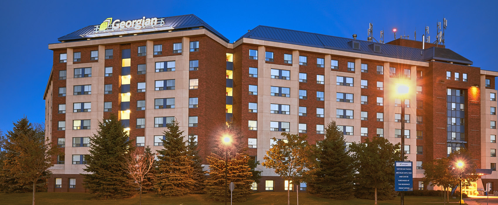 A photo taken at night of the front of the Georgian College Barrie campus residence