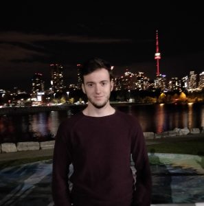 Sergio stands in front of the Toronto city skyline