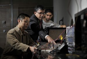 Professor helping students in engineering lab
