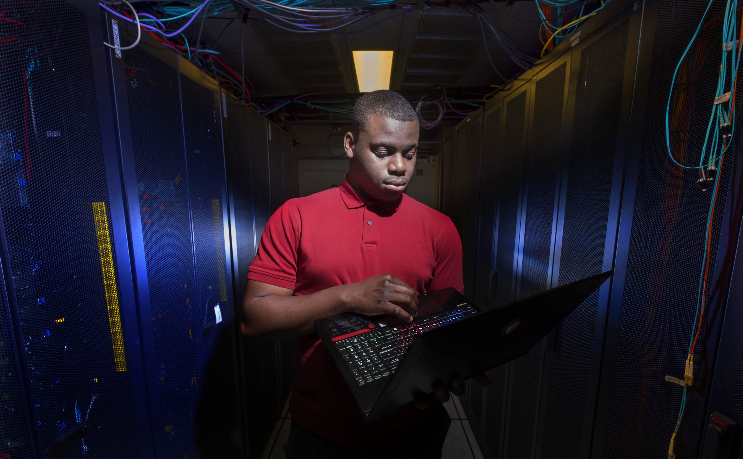 Tolu in data centre on campus with computer