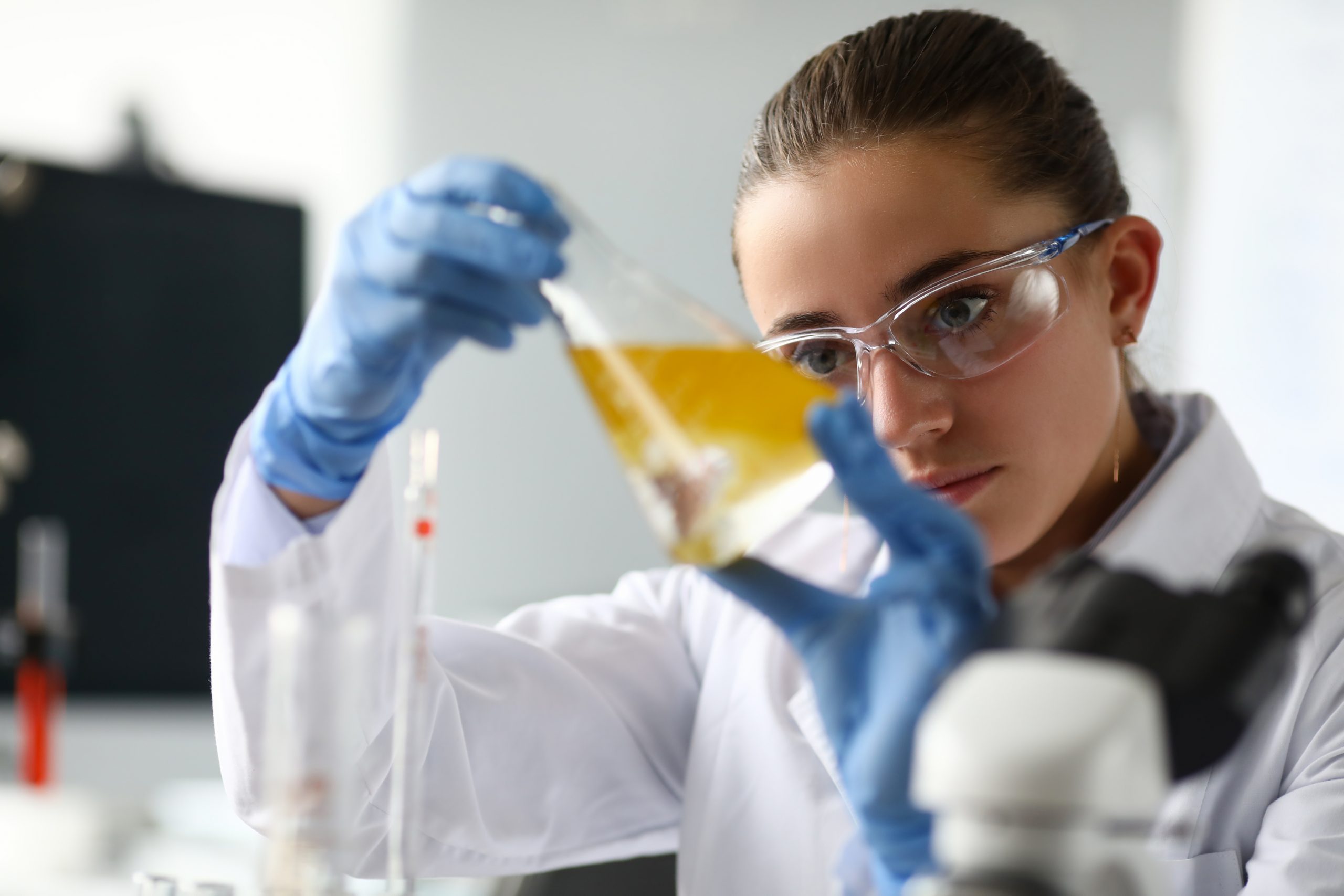 Science student looking into a flask