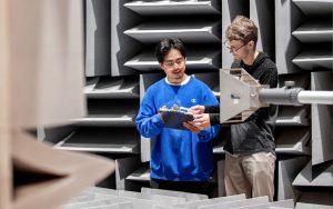 Two students conduct an experiment in the anechoic chamber